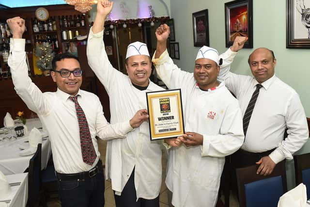 St John's Curry House staff triumphantly receive top prize