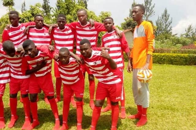The Kigali youth football team wearing their Bonnyrigg Rose strips.