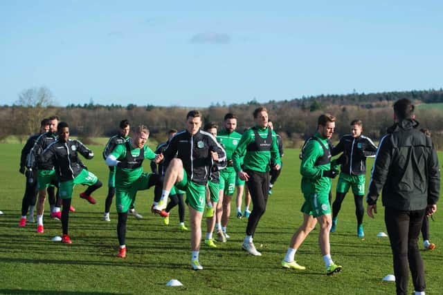 The Hibs squad are put through their paces at East Mains prior to the game.