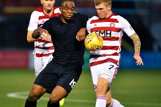 Uche Ikpeazu battles for possession as Hearts lose to Hamilton in December. Picture: SNS