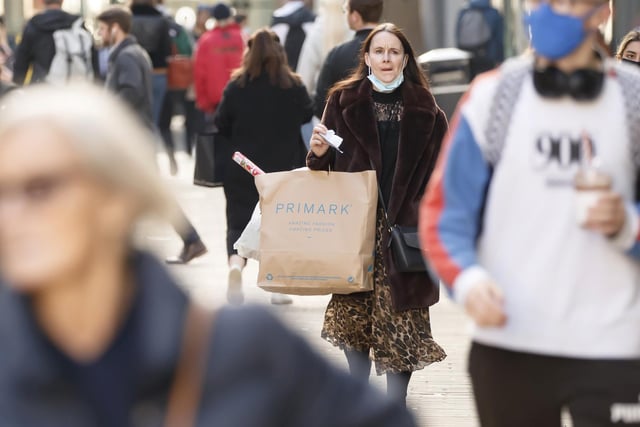 A shopper with a bag of Primark gear.