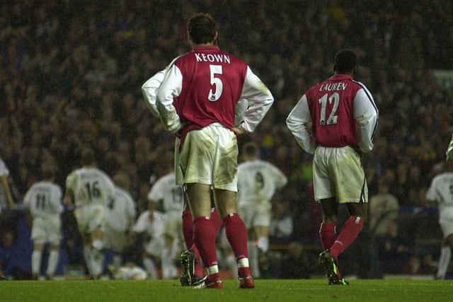 Dejected Arsenal players look on as Oliver Dacourt and the Leeds team celebrate after he scored what turned out to the winning goal.