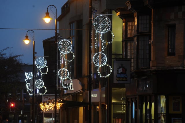 Bright lights above the town centre shopping streets.