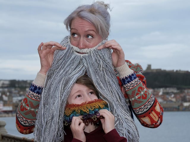Ollie Burton Hill peeps through the long beard of Lucy McGuire at Yorkshire Beard Day.