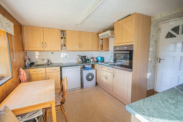 The dining kitchen has a range of fitted units and an integral cooker.