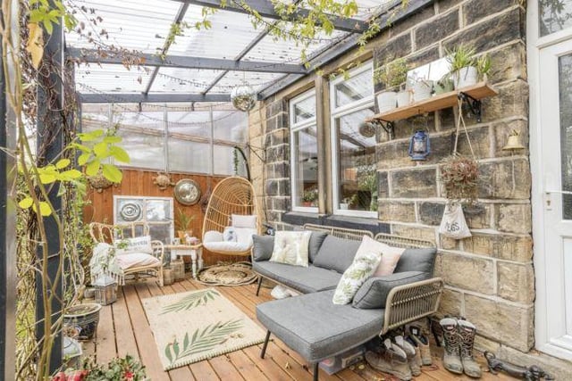 A surprising addition to the house is the lovely 'sun veranda' room. The current owners have made this a wonderful space to relax with lots of greenery and some outdoor furniture.