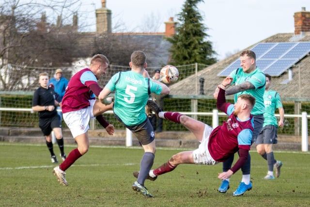 Acrobatics on show in a battle to win the ball. Picture: Mark Parsons