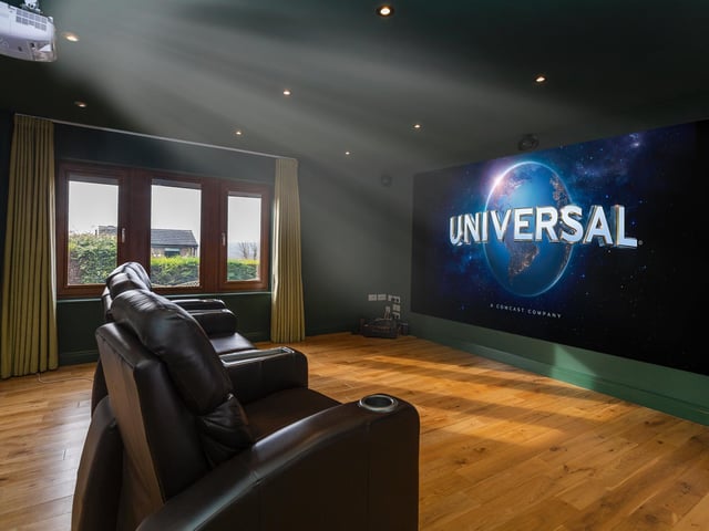 This room with flexible space is currently used as a cinema.