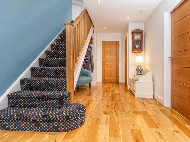 Oak doors lead in to the various rooms of the house from the hallway.