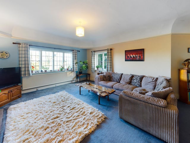 The lounge, with feature firpace and log burner, has plenty of natural light.