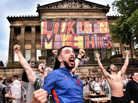England fans celebrate on the Flag Market