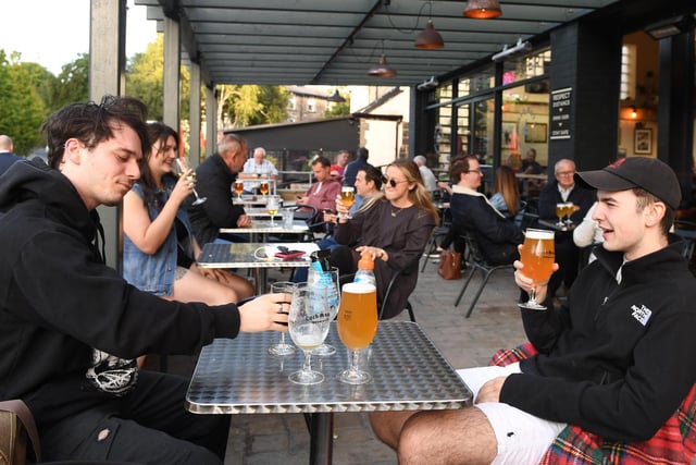 People enjoying a pint sat outside Cold Bath Brewing Co.