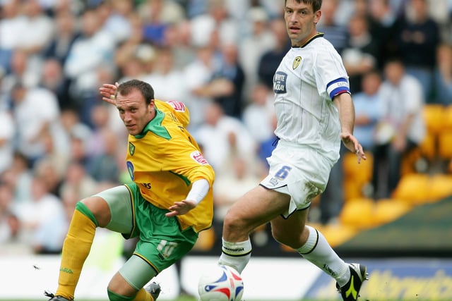 Norwich City striker Dean Ashton is tackled by Paul Butler during the Championship clash at Carrow Road in August 2005.
