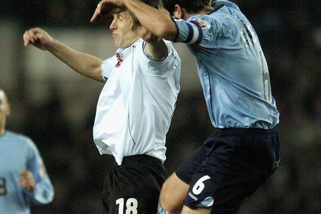 Paul Butler rises high with Derby County's Grzegorz Rasiak during the Championship clash at Pride Park in January 2005.