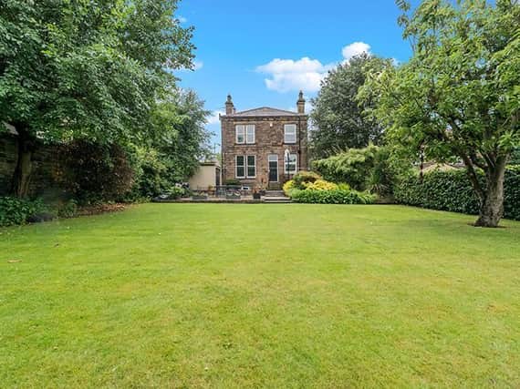 A stunning view of the property from its extensive lawned garden.