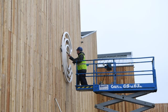 The lettering on the food hall being installed