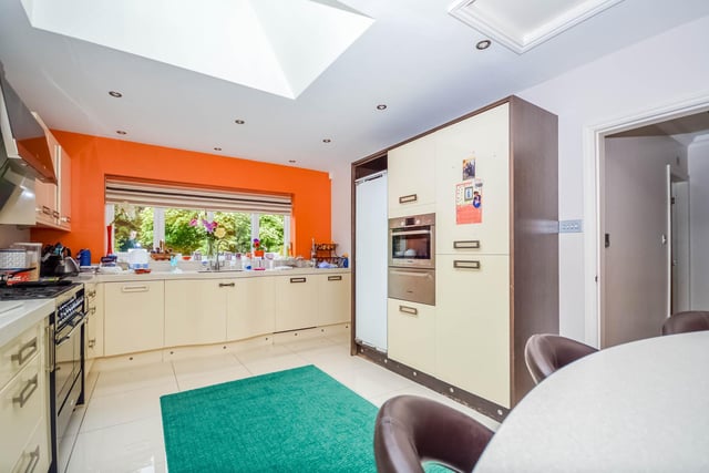 This well equipped kitchen has a breakfast bar and spotlights to the ceiling.