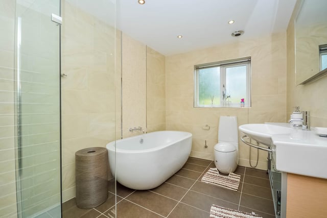 A deep bath and walk-in shower cubicle form part of this bathroom suite.