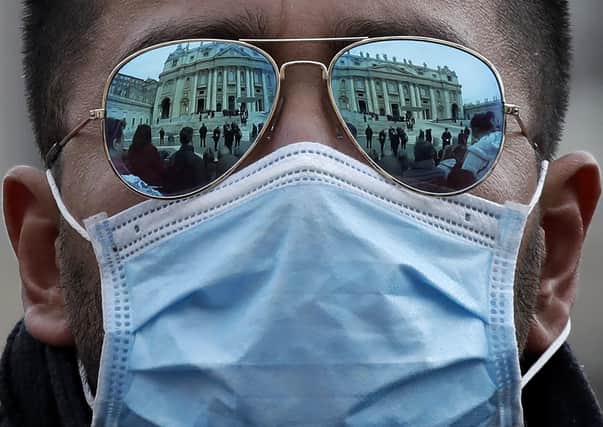 A man wears a face mask in St Peter's Square at the Vatican (Picture: AP Photo/Alessandra Tarantino)