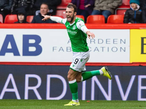 Hibs striker Christian Doidge turns to celebrate opening the scoring against Aberdeen at Pittodrie Pic: SNS