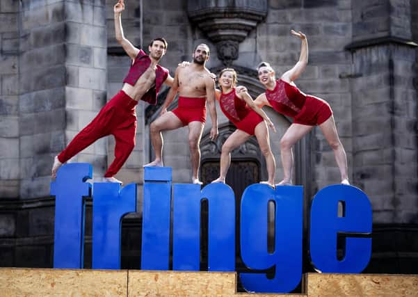 Some of the members from Australia's leading circus troupe 'Casus' celebrate the final week of the Edinburgh Fringe by performing excerpts from their acclaimed show DNA on top of the Royal Mile's 'Fringe' sign.  (Picture: Jane Barlow/PA Wire)