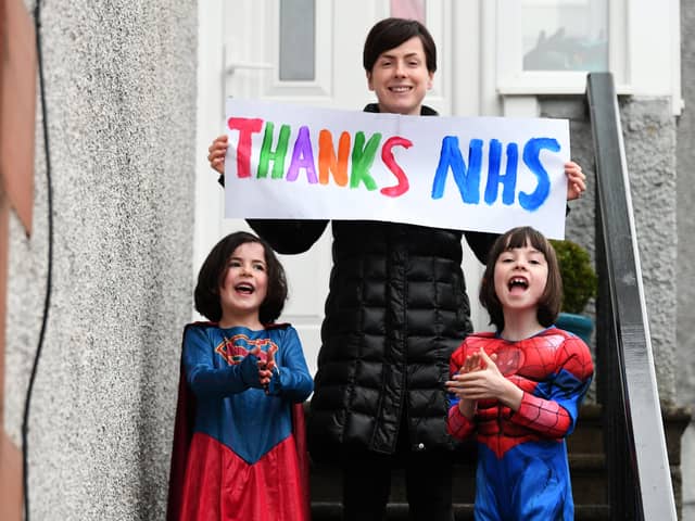 A family joins in the applause for the NHS in Glasgow (Picture: John Devlin)