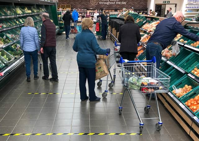 Tape marks out two-metre sections on the floor to implement social distancing measures at a Tesco store  (Picture: Joe Giddens/PA Wire)
