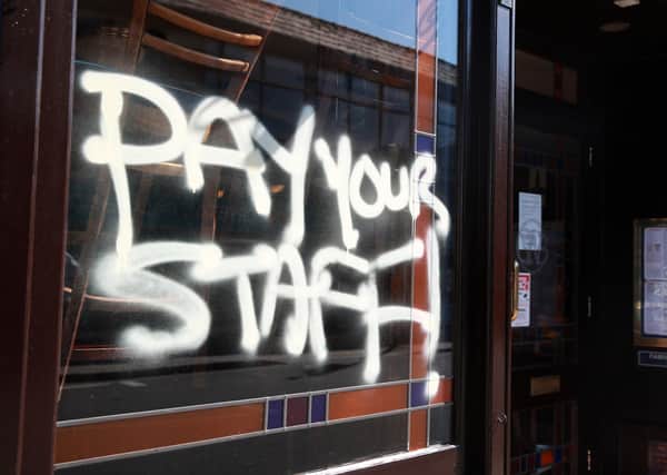 Graffiti on a JD Wetherspoon pub in London expressing anger at the pub chain's treatment of its workers (Picture: Adam Davy/PA)