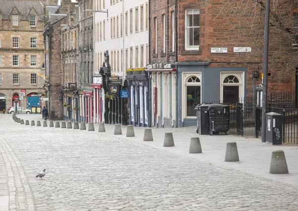 The Grassmarket, usually bustling, is deserted as Edinburgh residents heed the guidance to stay at home (Picture: Scot Louden)