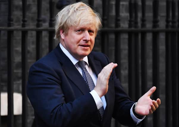 Boris Johnson claps for carers outside Downing Street amid signs that public support for the PM is on the slide (Picture: Leon Neal/Getty Images)