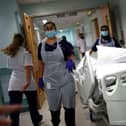 Medical staff transfer a patient along a corridor. Picture: Hannah McKay/AFP via Getty Images