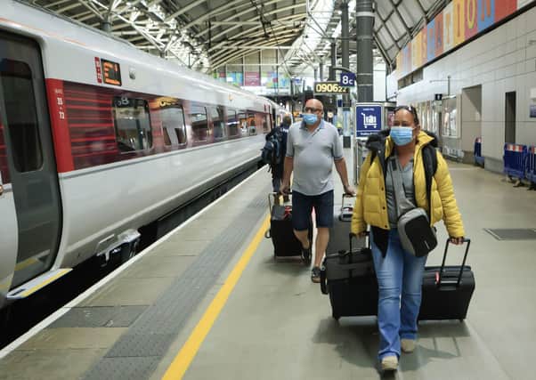 Travellers adapt to the new conditions by wearing face masks for journeys by rail (Picture: Danny Lawson/PA Wire)