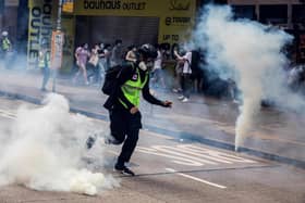Police fire tear gas on protesters during protests against new security legislation banning treason, subversion and sedition (Picture: Isaac Lawrence/AFP via Getty Images)