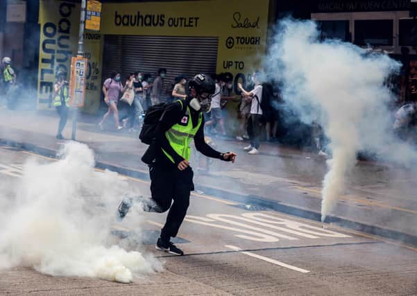 Police fire tear gas on protesters during protests against new security legislation banning treason, subversion and sedition (Picture: Isaac Lawrence/AFP via Getty Images)