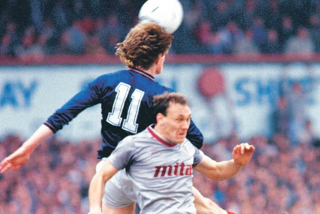 Hearts' Sandy Clark challenges Dundee's Colin Hendry. Picture: SNS