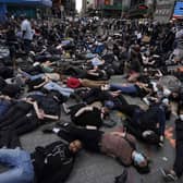 Protestors lie on the ground with their hands behind their back in a call for justice for George Floyd in Times Square, New York, during a “Black Lives Matter” protest (Picture: Timothy A Clary/AFP via Getty Images)