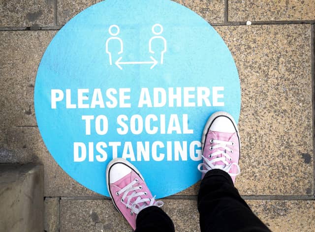 Social distancing sign outside a shop on the pavement in Princes Street (Picture: Jane Barlow/PA Wire)