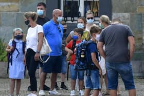 Parents have been warned not to gather with children near school gates to avoid the spread of coronavirus. Picture: AP Photo/Martin Meissner