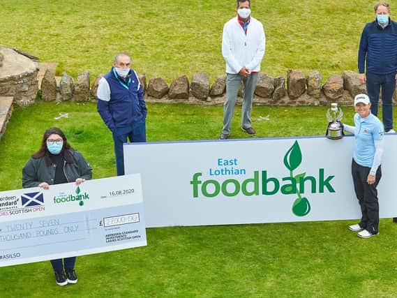 Stacey Lewis with volunteers from East Lothian Foodbank and their cheque