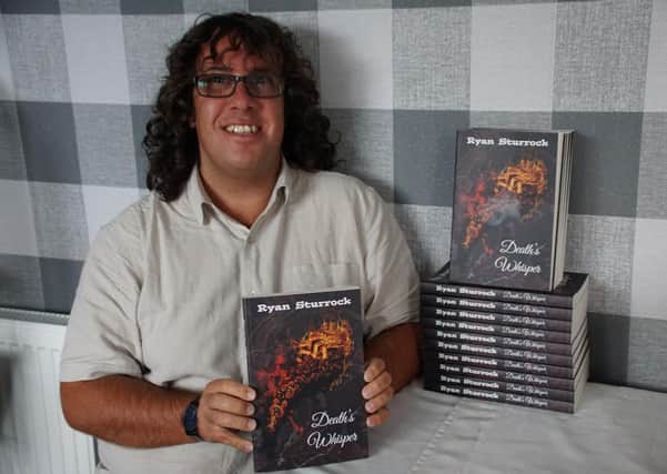 Ryan Sturrock with his debut novel Death’s Whisper, now available on Kindle and in paperback from Amazon.