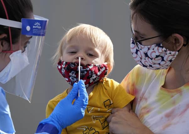 A young child is tested for Covid-19 (Picture: AP)