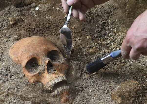 An archaeologist uncovers a skull dating back around 500 yearsin Leith (Picture: Lisa Ferguson)