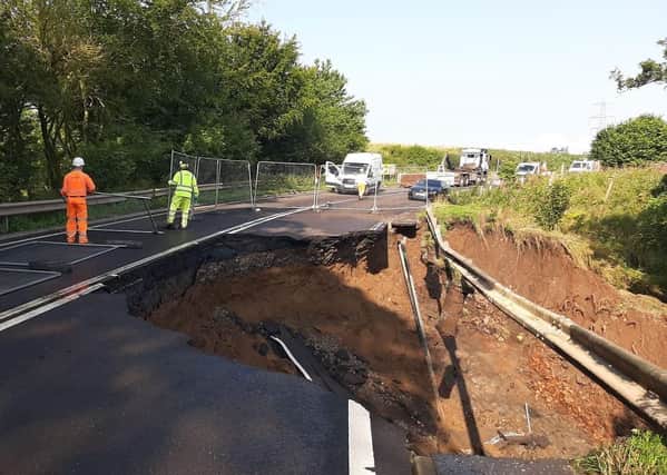 Fencing is put up where a massive section of the A68 between Pathhead and Fala Dam collapsed