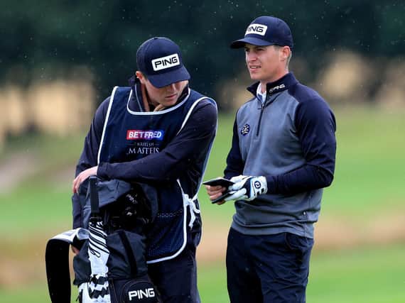Calum Hill, right, with his brother who is working as his caddy.