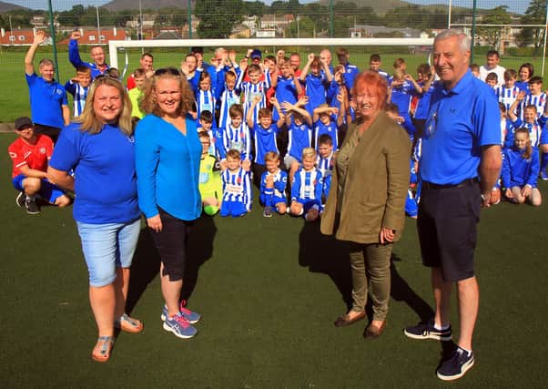The petition launch in August 2019. Louise Shepherd (Club Development Officer at PAYFC,) Cllr Debbi McCall, Christine Grahame MSP and Colin Pryde (PAYFC chairman) alongside players and volunteers on the troubled 3G  astro pitch in Penicuik.