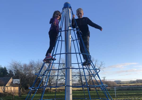 Emily and Charlie Trotter, pictured, are among scores of local children enjoying new play equipment in Fala thanks to a community venture supported by Midlothian Council.