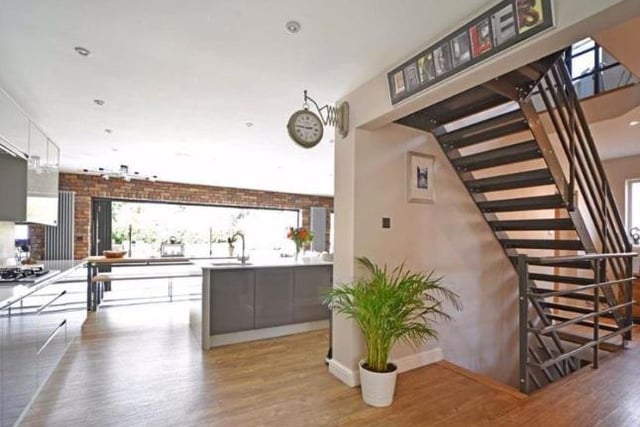 The staircase can be found within the open plan kitchen and sitting room. It is made with Amtico oak style flooring and steel and provides access to the first floor and the basement.