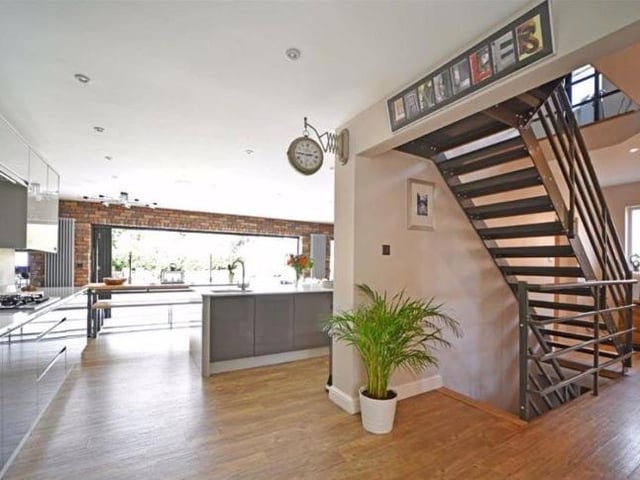 The staircase can be found within the open plan kitchen and sitting room. It is made with Amtico oak style flooring and steel and provides access to the first floor and the basement.