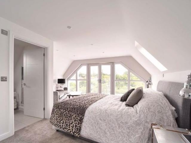 A commodious room with a vaulted ceiling, roof lights and french doors opening to a glass juliet balcony overlooking the rear garden. It has its own en suite shower room and dressing room.