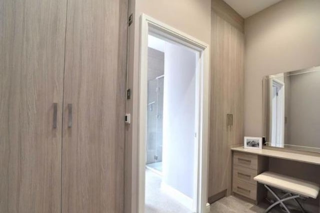 The dressing room has triple fitted wardrobes with shelving and hanging space, a heated towel rail as well as a dressing table. A door leads to the en suite bathroom.